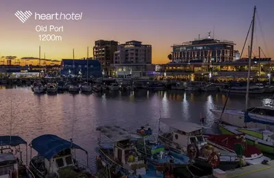 a group of boats docked in a marina at night at Heart Hotel in Limassol