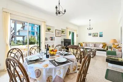 a dining room with a table and chairs at Villa 361-Walk to Protaras Fig Tree Bay & Amenities in Protaras