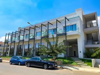 two cars parked in front of a building at Mythical Spa Suite - GYM*Yoga Room*Pools in Protaras