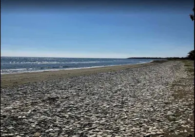 a rocky beach with the ocean in the background at Villa Poseidon in Pervolia