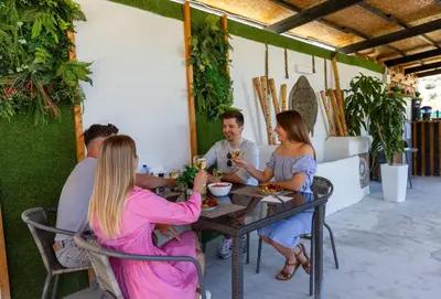 a group of people sitting at a table in a restaurant at Amazing Cyprus Glamping Domes - Glamping Cyprus in Paphos City