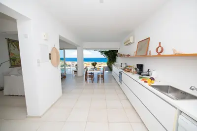 a white kitchen with a view of the ocean at Jasmine Sea Front Villa in Protaras