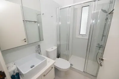a bathroom with a toilet and a sink and a shower at Jasmine Sea Front Villa in Protaras