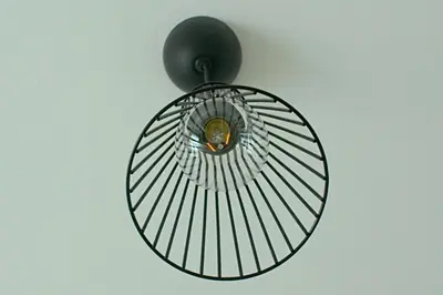 a circular light fixture hanging from a ceiling at ALEX APARTMENT in Strovolos