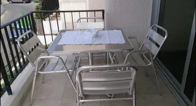 a table and chairs sitting on a balcony at Ayia Napa Luxury Apartment in Ayia Napa