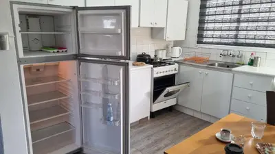 a kitchen with an empty refrigerator and a stove at Elpida Lemon Garden House in Limassol