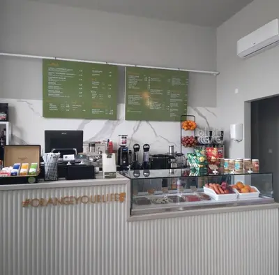 a fast food restaurant with a counter with signs on the wall at Pebble in Protaras
