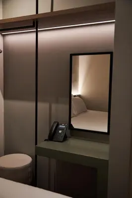 a mirror on a desk with a phone on it at Alinea Primo Historic Center in Limassol