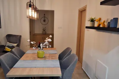 a dining room with a wooden table and chairs at Sweet Retreat in Paralimni