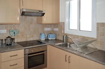 a kitchen with a sink and a stove at Sweet Retreat in Paralimni