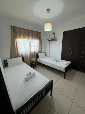 a bedroom with two beds with towels on them at Seaview Harmony in Larnaka