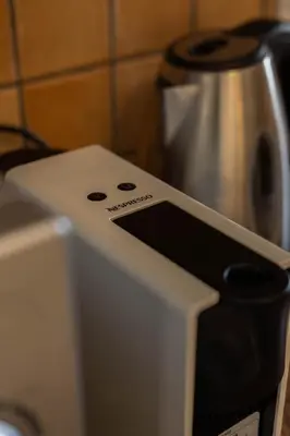 a white toaster oven with a coffee pot at Seaview Harmony in Larnaka