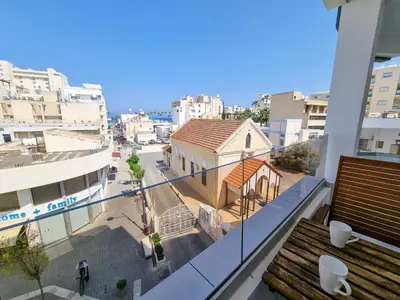 a view of a city from the balcony of a building at Sea Bay Apartment in Larnaka