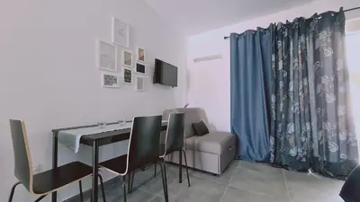 a dining room with a table and chairs and a couch at Nissi avenue 64 Studio 2 - Luxcyservices in Ayia Napa