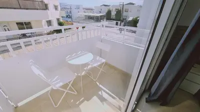 a balcony with a white table and chair on it at STAY Lavish Studio in Ayia Napa