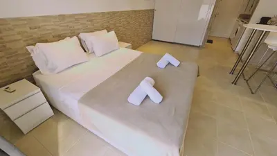 a large bed with two white bows on it at STAY Lavish Studio in Ayia Napa