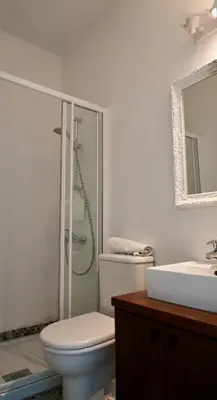 a bathroom with a toilet and a shower and a sink at Narcissus 18 in Paralimni
