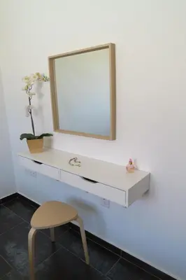 a white dressing table with a mirror and a chair at Mythical Sands AM10 in Paralimni