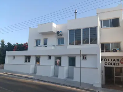 a white building on the side of a street at PoliaNapa Nest in Ayia Napa