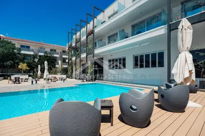 a swimming pool in front of a building at SunnyVillas: 2BR Mythical Apt*Swimming Pool*AK04 in Paralimni
