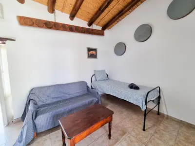 a living room with a couch and a table at Poseidon's Pool Paradise in Skarinou