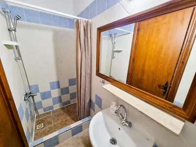 a bathroom with a sink and a mirror at Poseidon's Pool Paradise in Skarinou