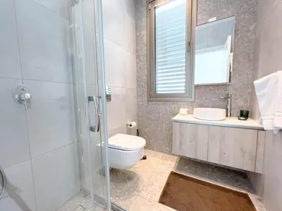 a bathroom with a toilet and a sink and a shower at Azure Seaview - Jade Villa in Protaras