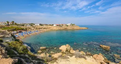 a beach with a bunch of people in the water at Azure Seaview - Jade Villa in Protaras