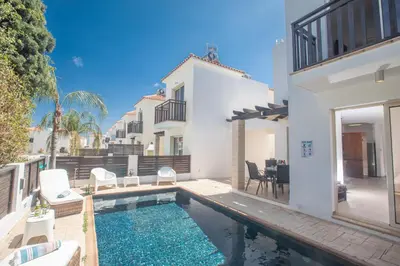 a swimming pool in the backyard of a house at Sunny Side Up Villa in Protaras