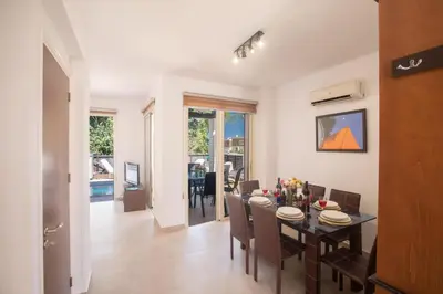 a dining room and living room with a table and chairs at Sunny Side Up Villa in Protaras
