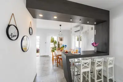 a kitchen and dining room with a table and chairs at Napa Bay View Villa 3 in Ayia Napa