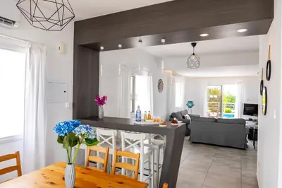 a kitchen and living room with a table and chairs at Napa Bay View Villa 3 in Ayia Napa