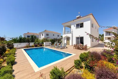 a villa with a swimming pool in front of a house at Napa Bay View Villa 3 in Ayia Napa
