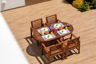 a wooden table with plates of food on it at Napa Bay View Villa 3 in Ayia Napa