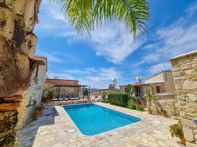 a swimming pool in a villa with a palm tree at Aphrodite's Pool Retreat in Skarinou