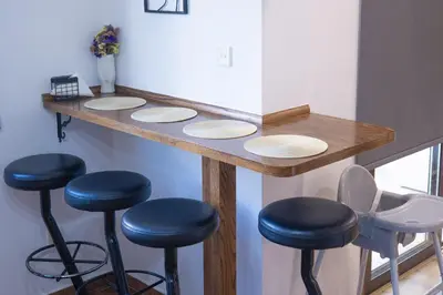 a bar counter with stools in a room at Maestro Sea - View Apartment in Larnaka