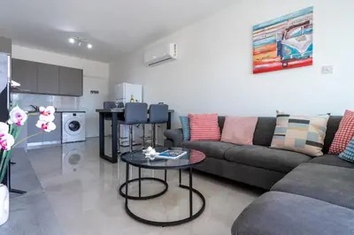 a living room with a couch and a table at Andrea 3-Bedroom Apt in Mackenzie in Larnaka