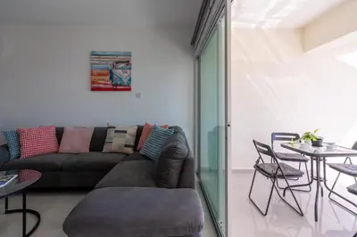 a living room with a couch and a table at Andrea 3-Bedroom Apt in Mackenzie in Larnaka