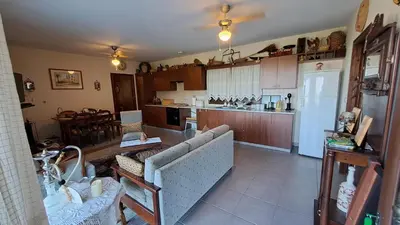 a large kitchen with a couch and a refrigerator at Mountain View 2BR House with Garden & Free Parking Ioannis Ylation Saranti in Nicosia