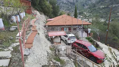 a red car parked in front of a train station at Mountain View 2BR House with Garden & Free Parking Ioannis Ylation Saranti in Nicosia